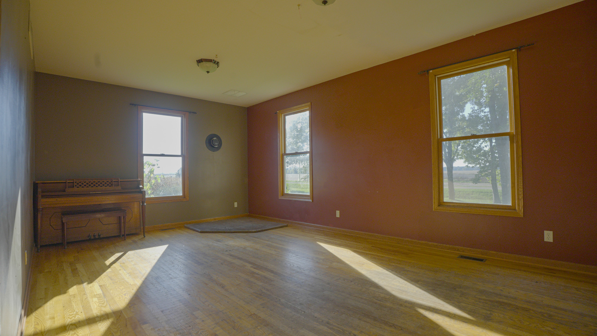 9282 East Hemstock Road Rochelle, IL 61068 - Photo 8 of 68 a view of an empty room with a window and wooden floor