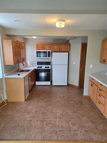 a kitchen with a stove and a refrigerator