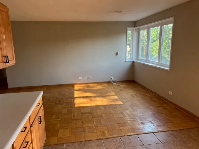 a large kitchen with stainless steel appliances granite countertop a stove a sink and a granite counter tops with white cabinets