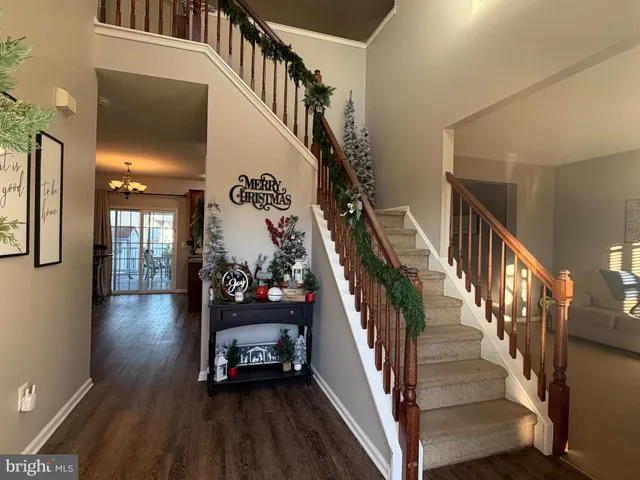 a view of a livingroom with wooden floor and stairs
