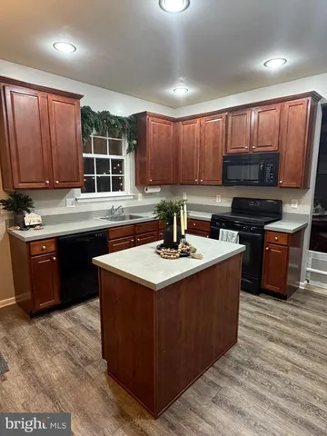 a kitchen with a stove sink and cabinets