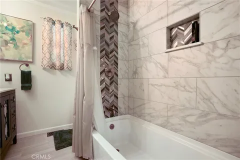 a bathroom with a bathtub and shower