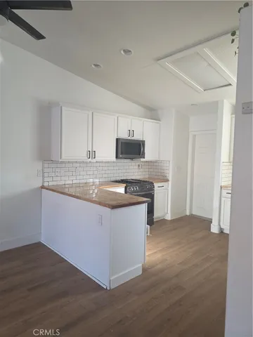 a kitchen with stainless steel appliances granite countertop a stove and a sink