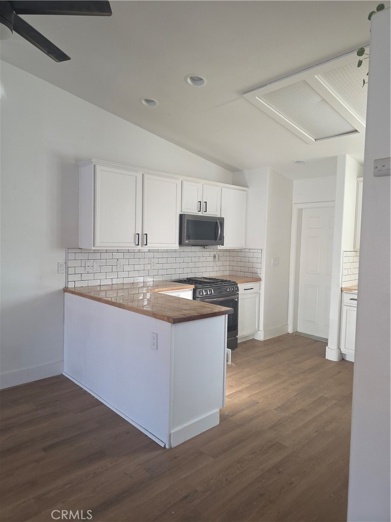 a kitchen with stainless steel appliances granite countertop a stove and a sink