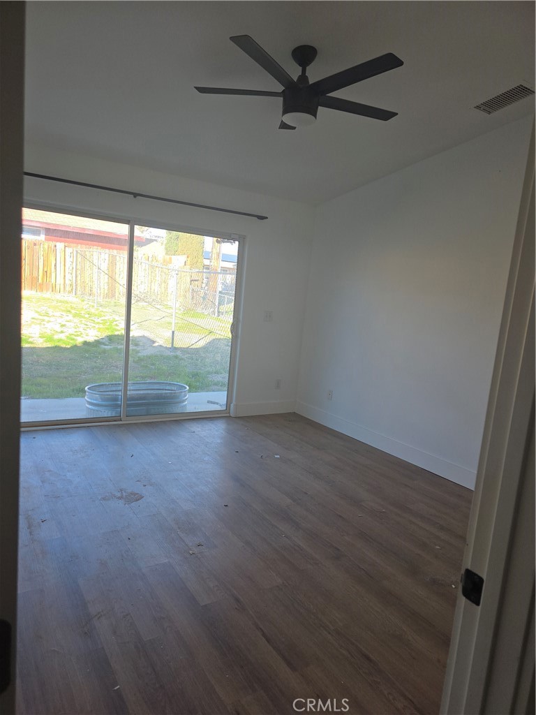 57336 Crestview Drive Yucca Valley, CA 92284 - Photo 11 of 19 an empty room with wooden floor and fan