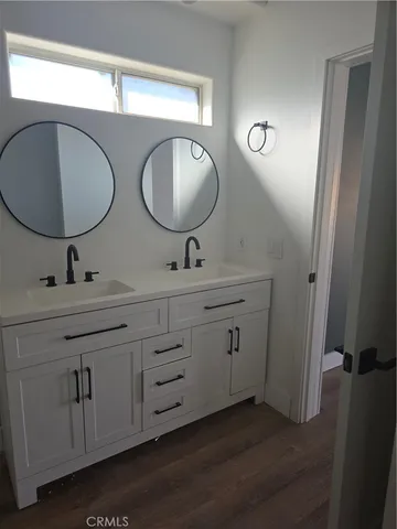 a bathroom with a sink a mirror and shower