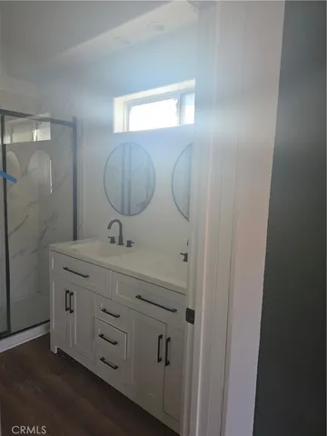 a bathroom with a glass shower door