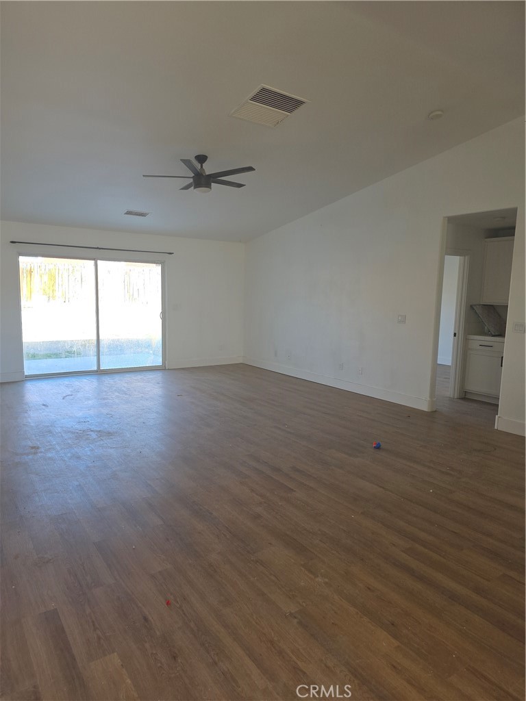 57336 Crestview Drive Yucca Valley, CA 92284 - Photo 6 of 19 an empty room with wooden floor and windows