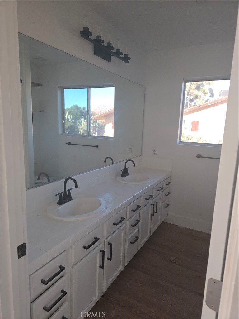 57336 Crestview Drive Yucca Valley, CA 92284 - Photo 10 of 19 a bathroom with double vanity sink a mirror and a window