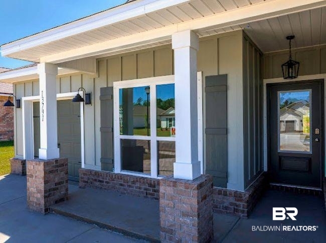 13791 Logan Place Foley, AL 36535 - Photo 4 of 25 Covered front porch featuring brick columns and board and batten siding