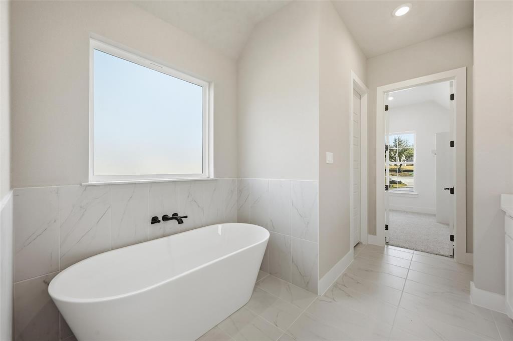 1053 Llano Way Poolville, TX 76487 - Photo 26 of 40 a white bath tub sitting in a bathroom