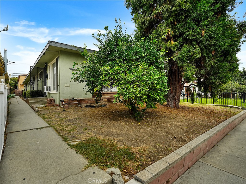 a backyard of a house with large trees