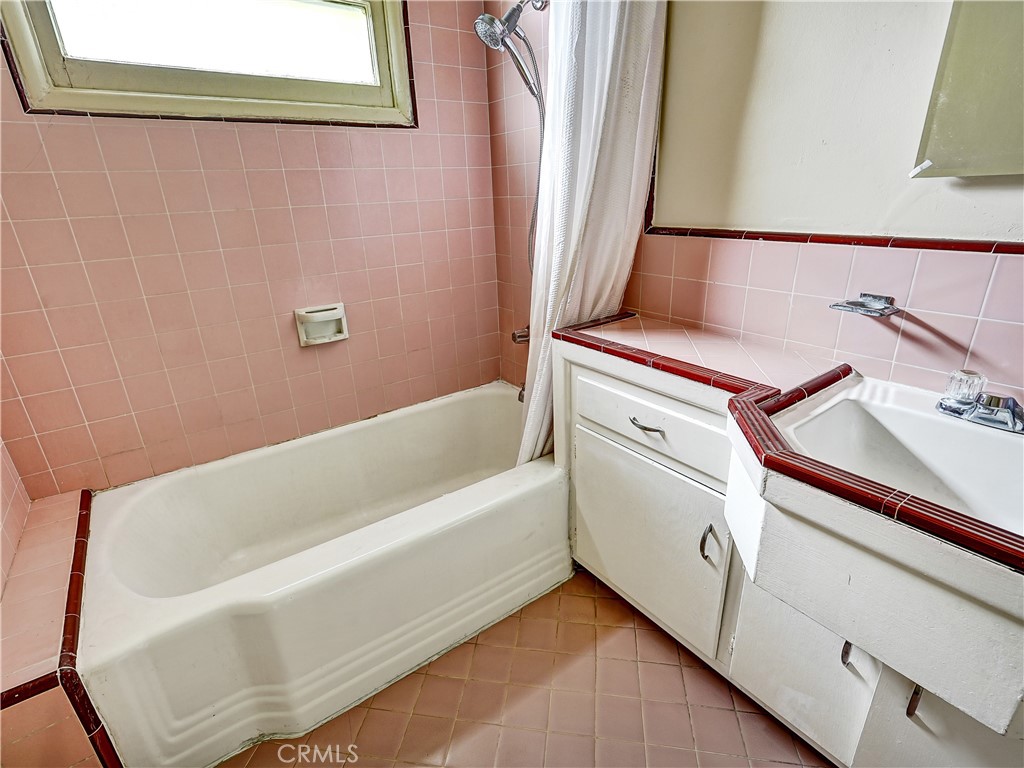 7928 Milton Avenue Whittier, CA 90602 - Photo 11 of 27 a bathroom with a bathtub and shower