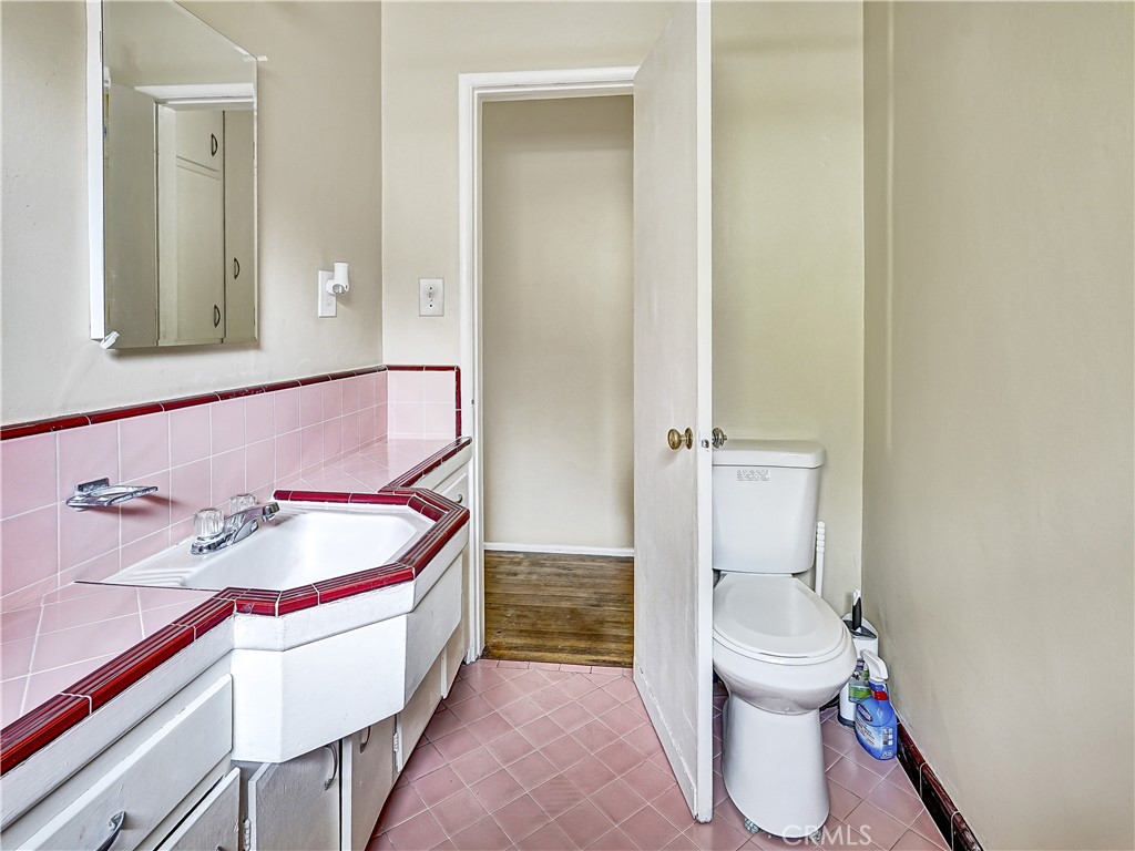 7928 Milton Avenue Whittier, CA 90602 - Photo 12 of 27 a bathroom with a sink and a mirror