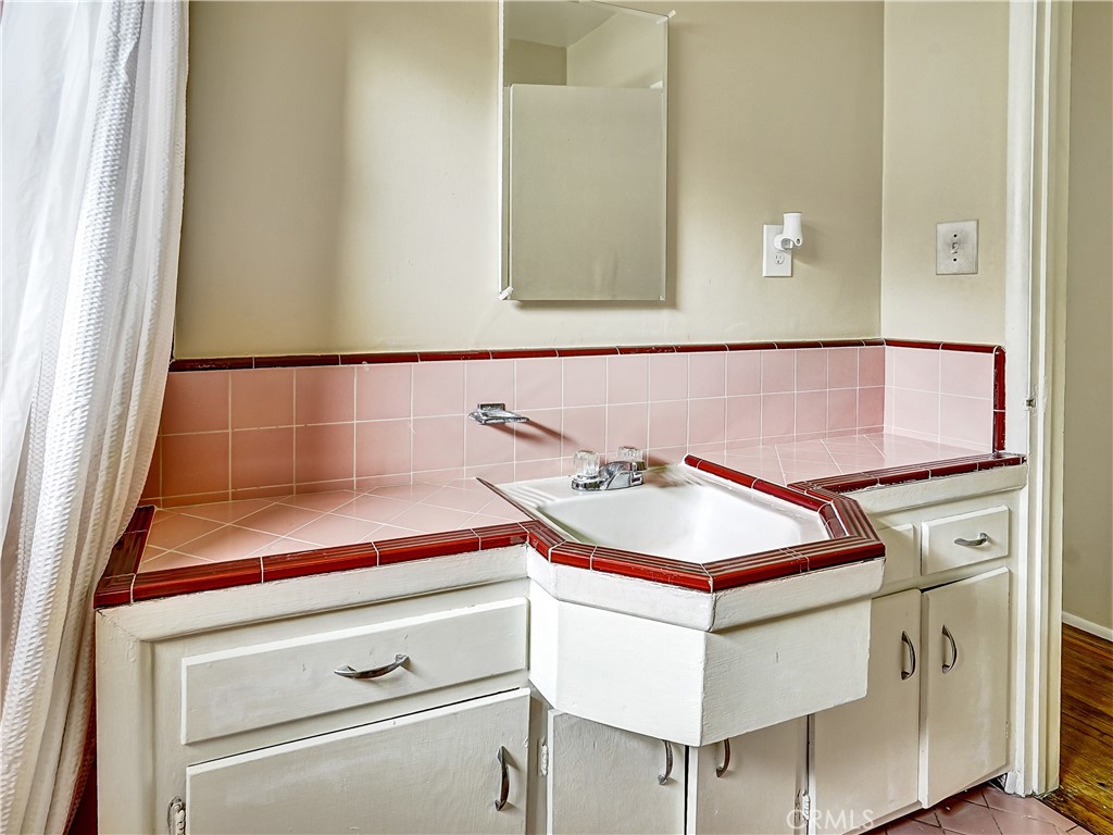7928 Milton Avenue Whittier, CA 90602 - Photo 14 of 27 a bathroom with a sink and a mirror