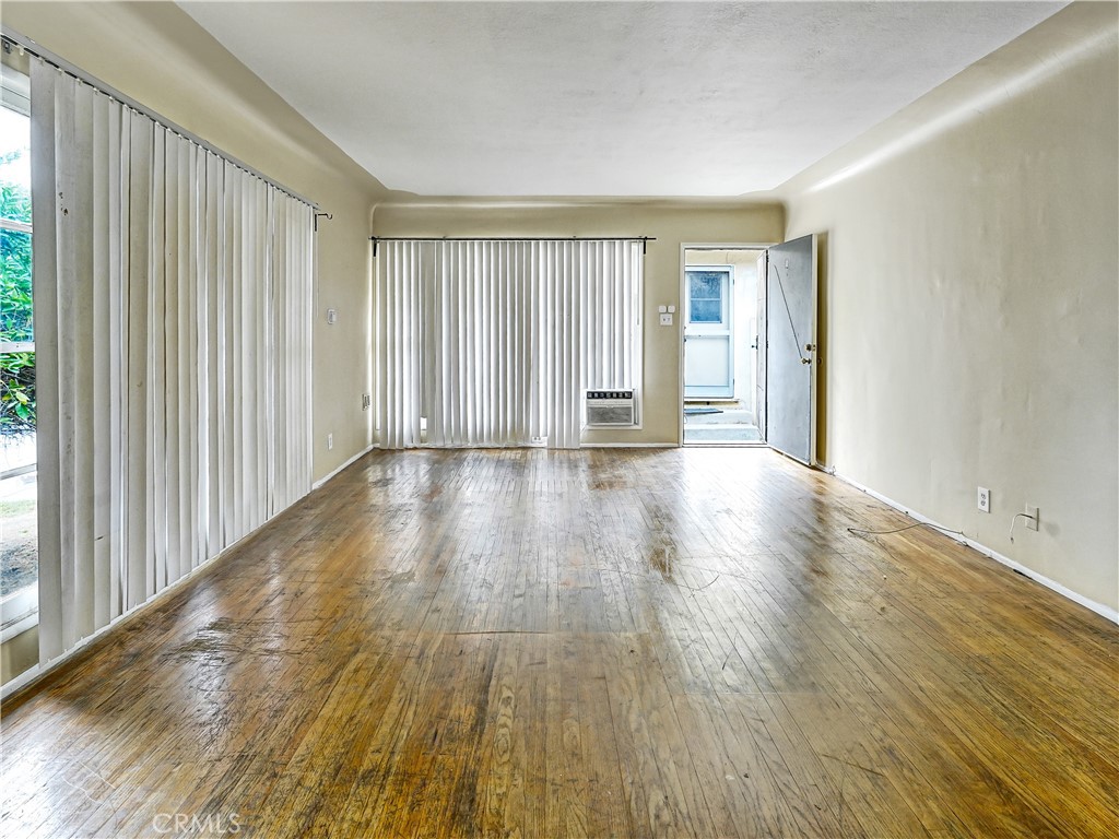 7928 Milton Avenue Whittier, CA 90602 - Photo 16 of 27 a view of an empty room with wooden floor and a window