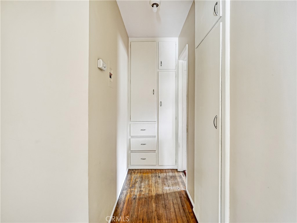7928 Milton Avenue Whittier, CA 90602 - Photo 9 of 27 a view of a hallway with wooden floor