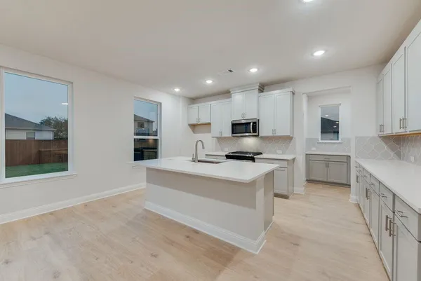 a kitchen with a sink and cabinets