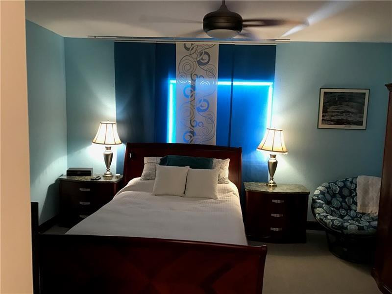 15038 Southwest 161st Place Miami, FL 33196 - Photo 13 of 23 a bedroom with a bed and lamp on dresser