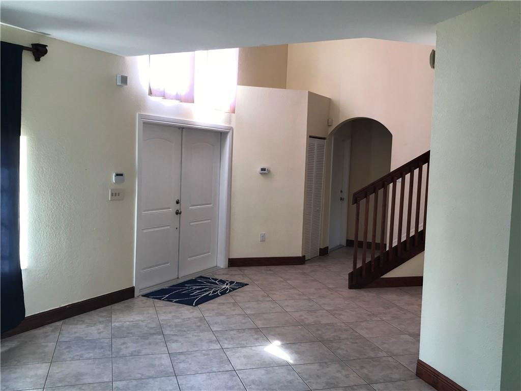 15038 Southwest 161st Place Miami, FL 33196 - Photo 2 of 23 a view of a livingroom with entryway and stairs