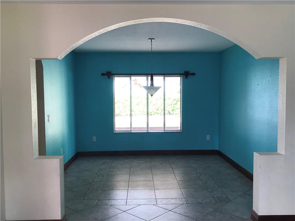 15038 Southwest 161st Place Miami, FL 33196 - Photo 5 of 23 an empty room with a window