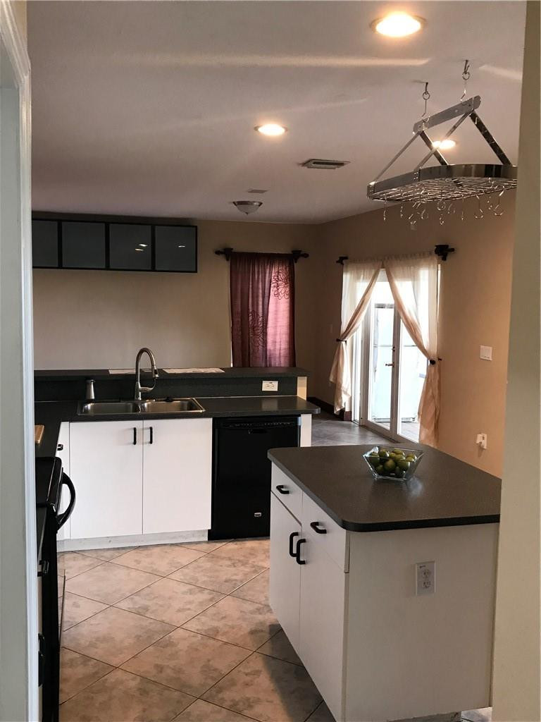 15038 Southwest 161st Place Miami, FL 33196 - Photo 7 of 23 a kitchen with stainless steel appliances granite countertop a sink a stove and a refrigerator