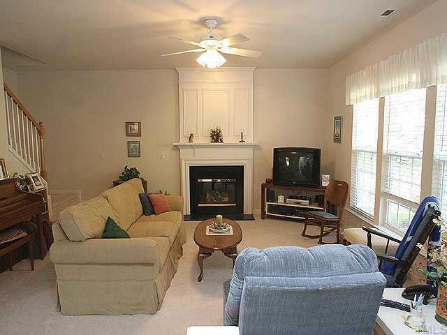 1617 October Road Raleigh, NC 27614 - Photo 4 of 9 a living room with furniture a flat screen tv and a fireplace