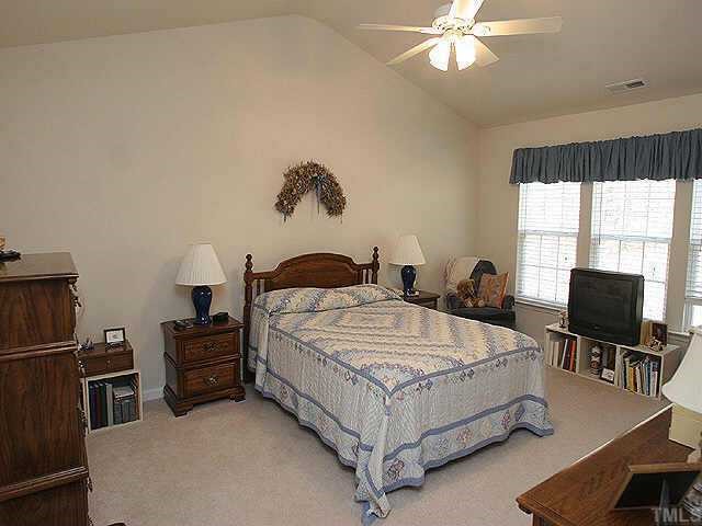 1617 October Road Raleigh, NC 27614 - Photo 7 of 9 a bedroom with a bed flat screen tv and window