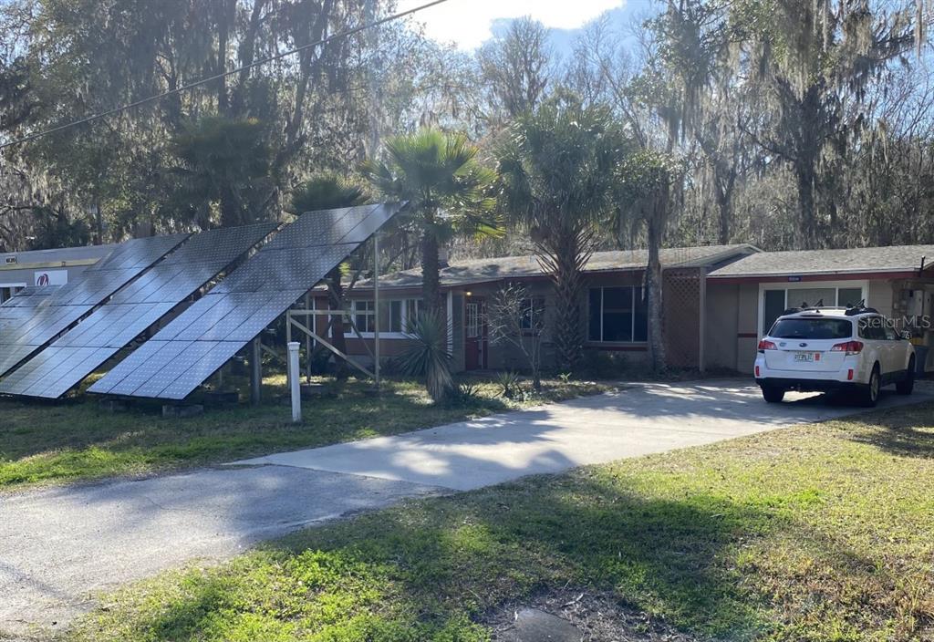 6110 Southwest 13th Street Gainesville, FL 32608 - Photo 2 of 7 a backyard of a house with barbeque oven table and chairs