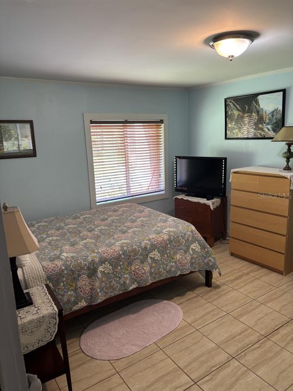 6110 Southwest 13th Street Gainesville, FL 32608 - Photo 6 of 7 a bedroom with a bed and a dresser