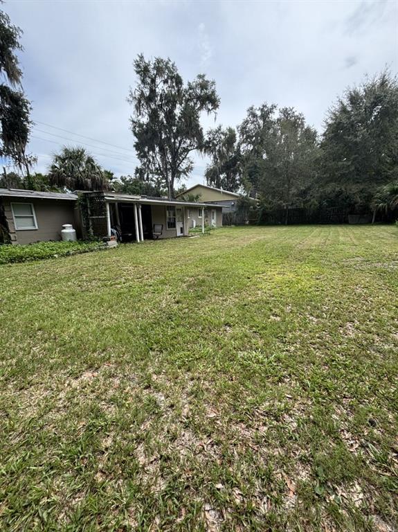 6110 Southwest 13th Street Gainesville, FL 32608 - Photo 7 of 7 a front view of a house with yard and green space