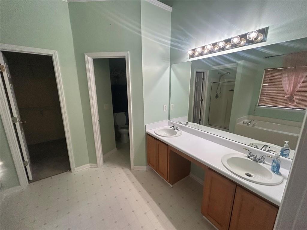 3220 Waterplace Cove Villa Rica, GA 30180 - Photo 14 of 36 a bathroom with a double vanity sink and a mirror