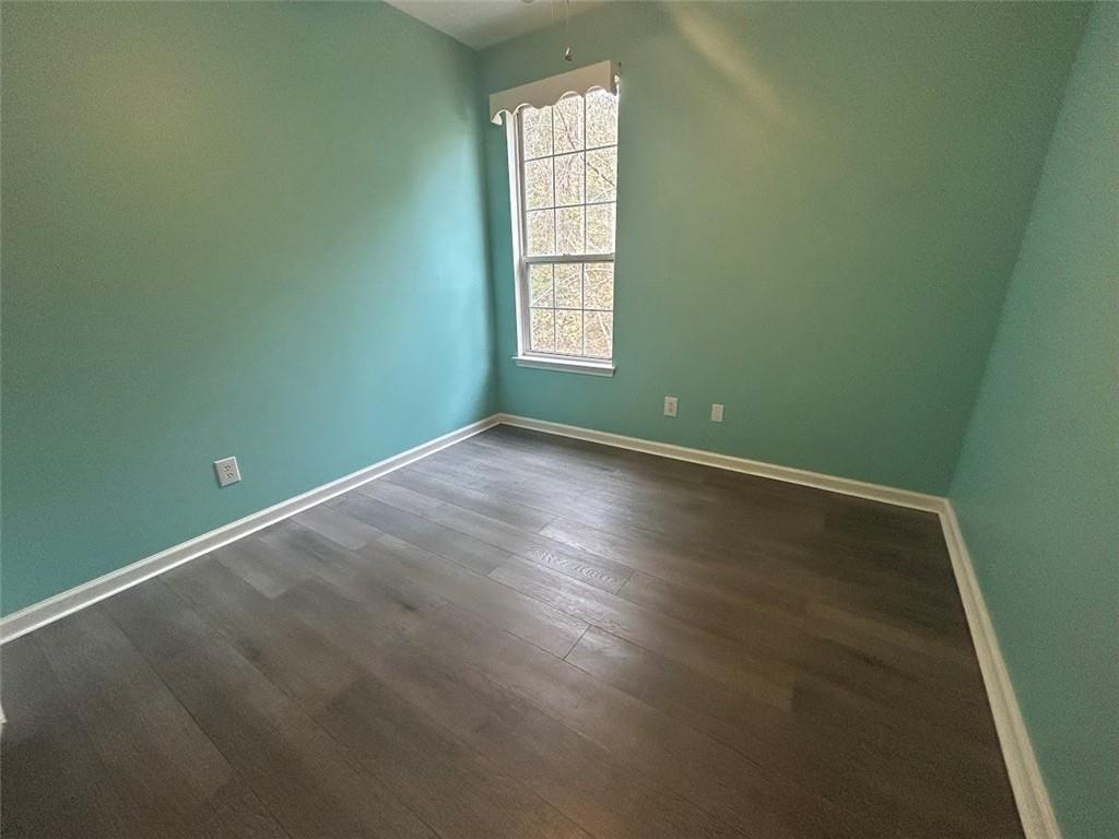 3220 Waterplace Cove Villa Rica, GA 30180 - Photo 16 of 36 an empty room with wooden floor and windows