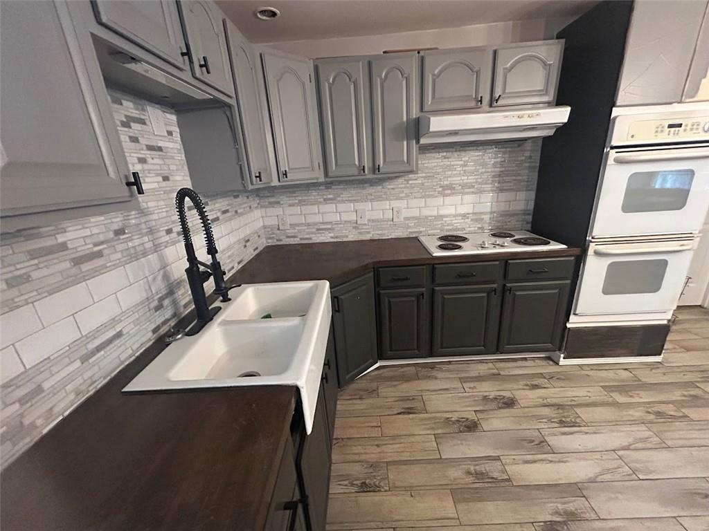 3220 Waterplace Cove Villa Rica, GA 30180 - Photo 24 of 36 a kitchen with a sink stove and cabinets