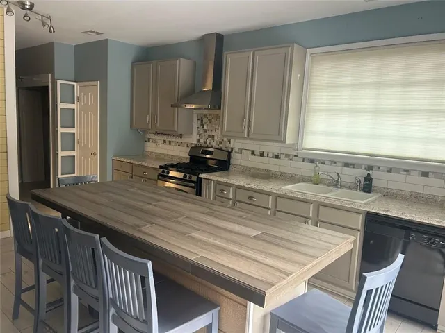 a kitchen with a sink stove and cabinets