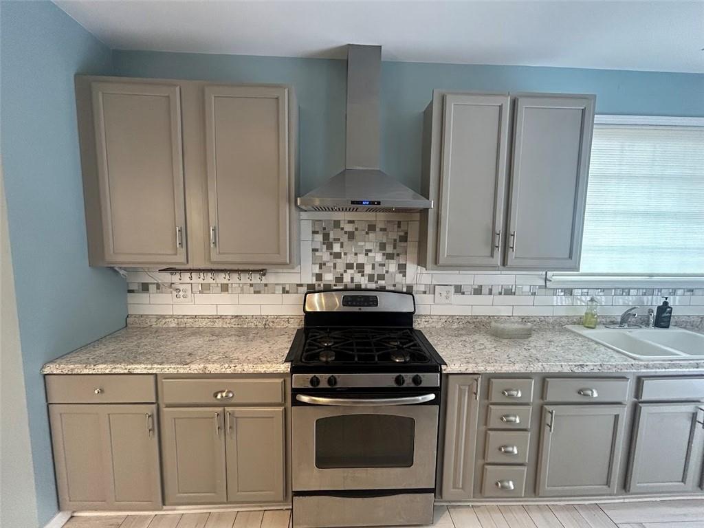 3220 Waterplace Cove Villa Rica, GA 30180 - Photo 8 of 36 a kitchen with granite countertop a stove sink and cabinets
