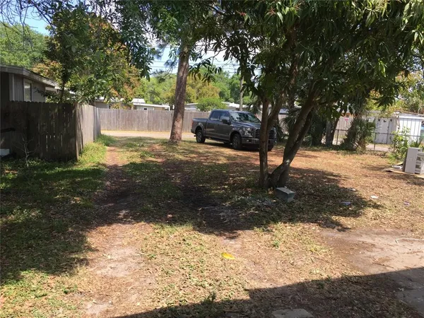 a view of a yard with a tree