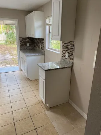 a kitchen with stainless steel appliances a sink a stove a microwave and a counter top space