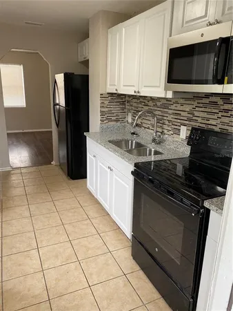 a kitchen with stainless steel appliances and cabinets