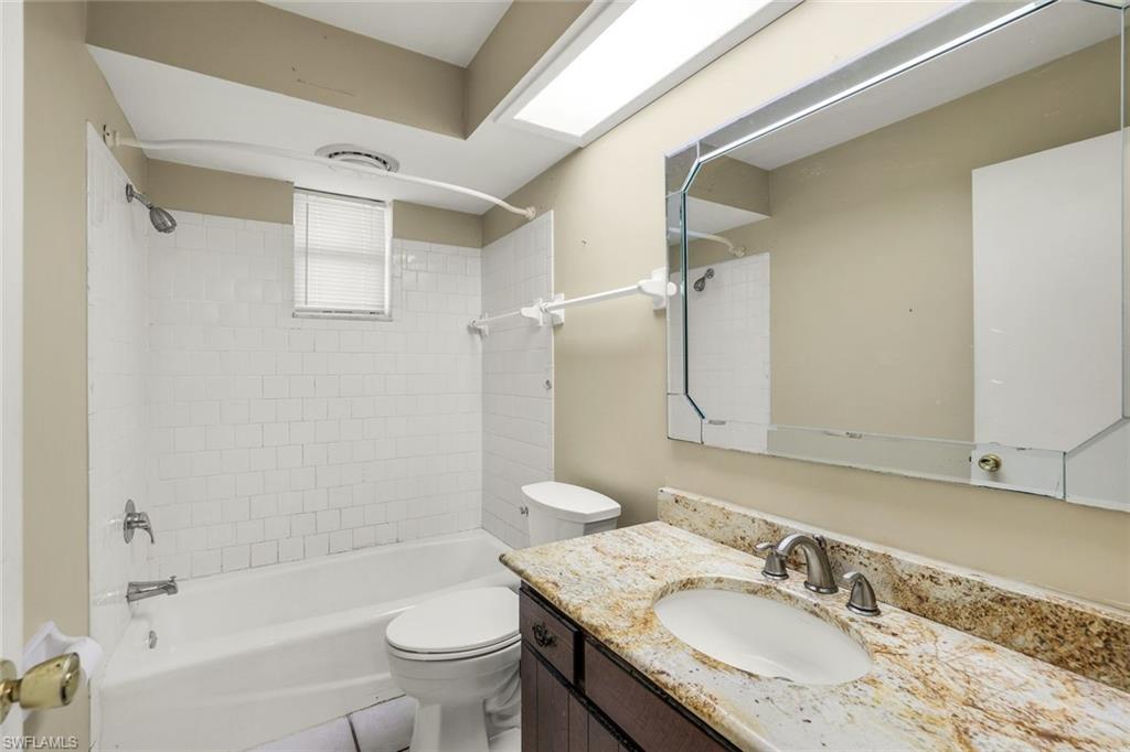 5290 Cypress Lane Naples, FL 34113 - Photo 23 of 39 a bathroom with a granite countertop sink toilet and shower