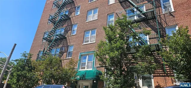 a front view of a residential apartment building with a front door