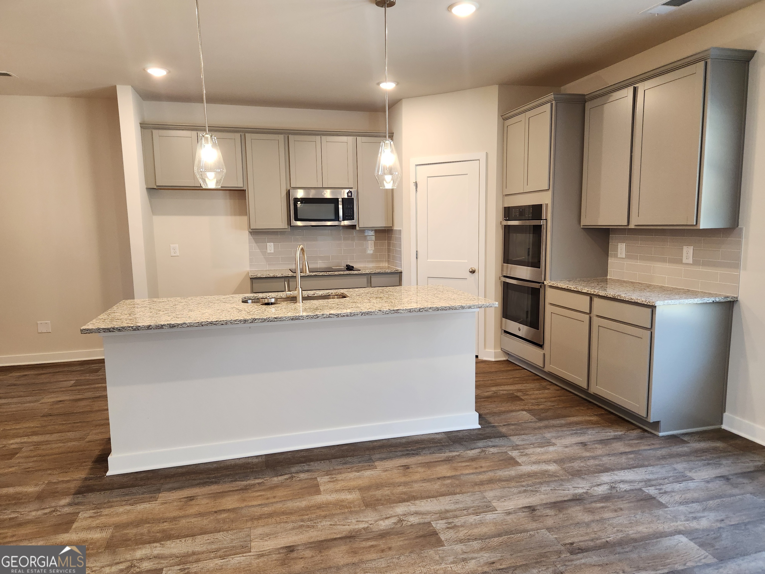 203 Crabapple Road, Unit 265 McDonough, GA 30253 - Photo 11 of 54 a large kitchen with stainless steel appliances granite countertop a stove a sink and a refrigerator