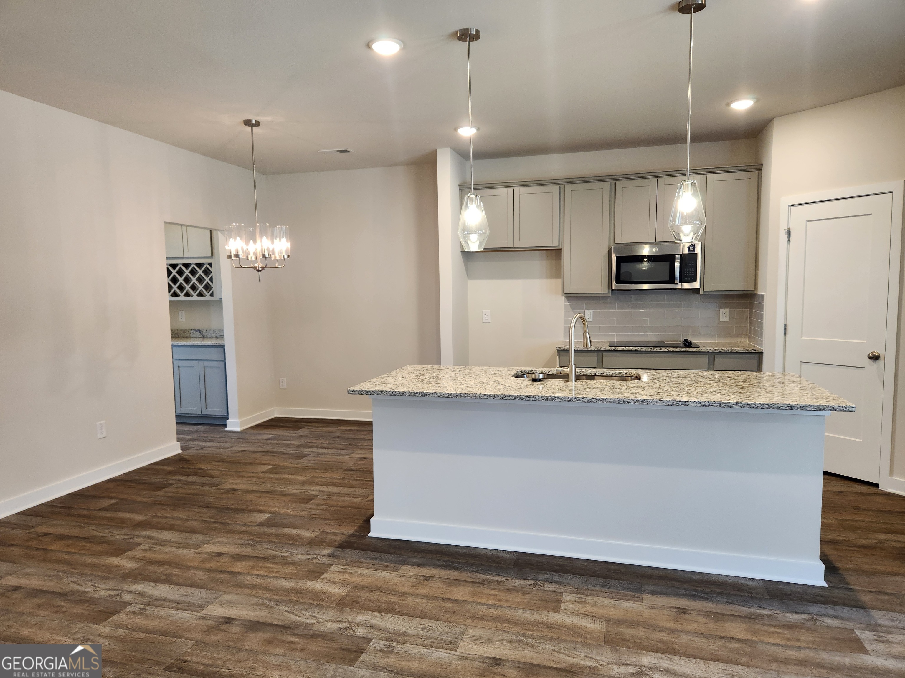 203 Crabapple Road, Unit 265 McDonough, GA 30253 - Photo 12 of 54 a view of kitchen with granite countertop stainless steel appliances sink and microwave
