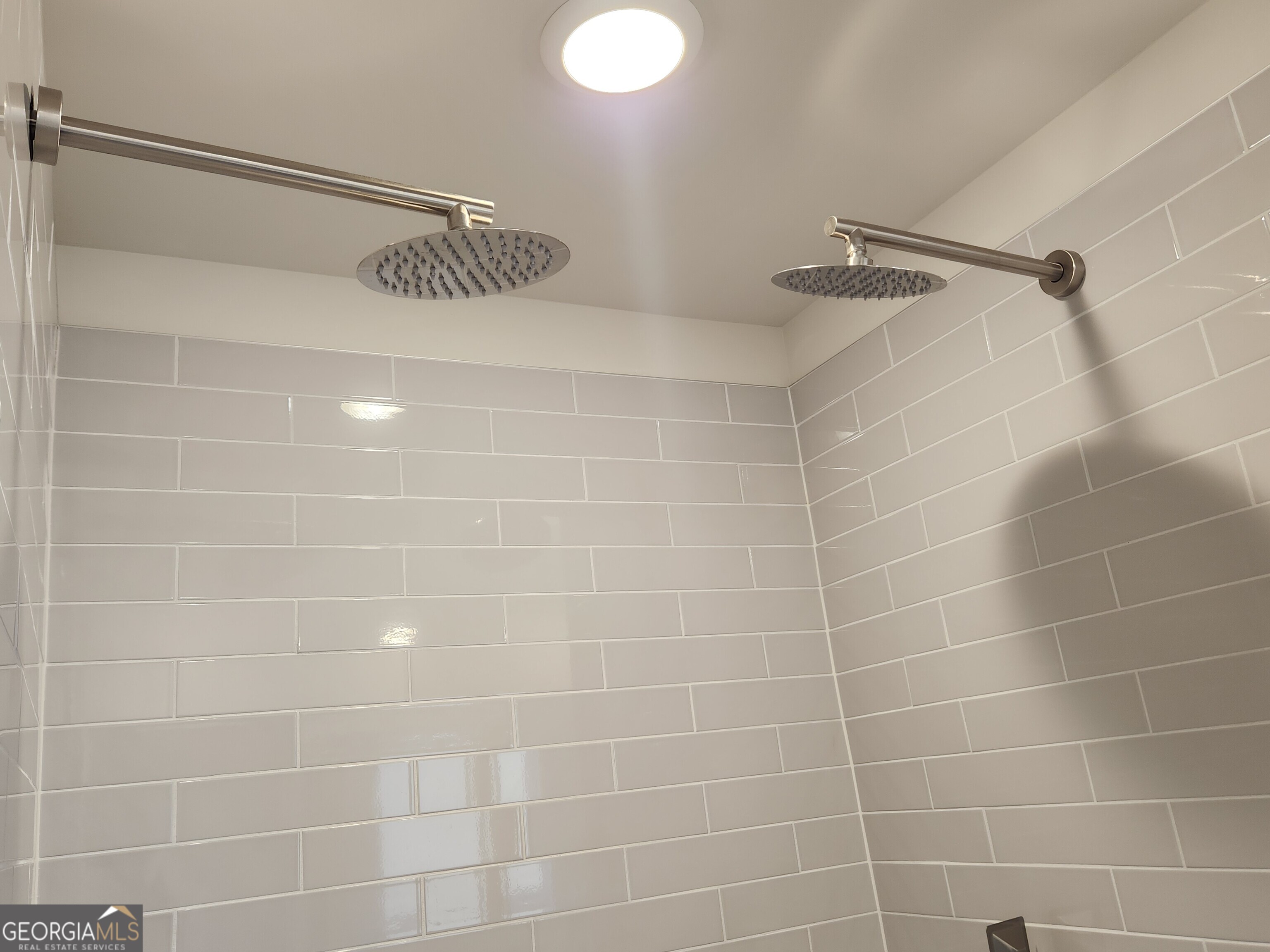 203 Crabapple Road, Unit 265 McDonough, GA 30253 - Photo 32 of 54 a bathroom with a shower and a mirror