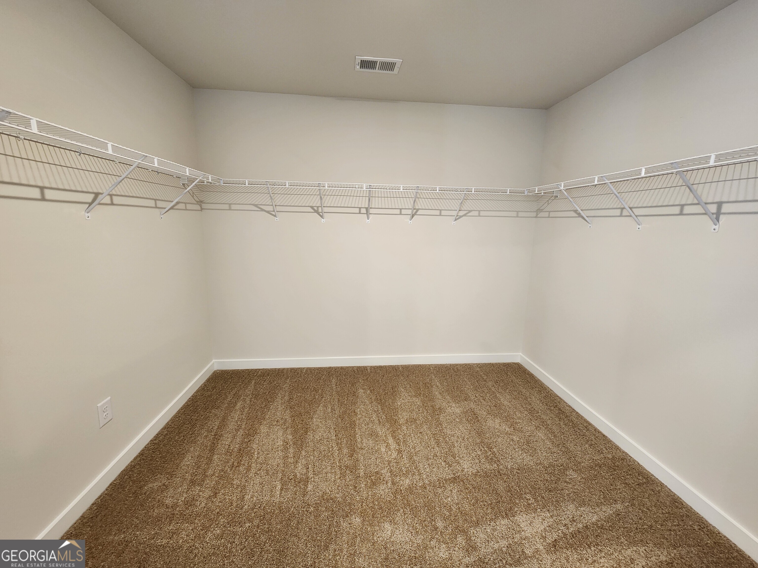 203 Crabapple Road, Unit 265 McDonough, GA 30253 - Photo 36 of 54 a view of a room with racks on the wall