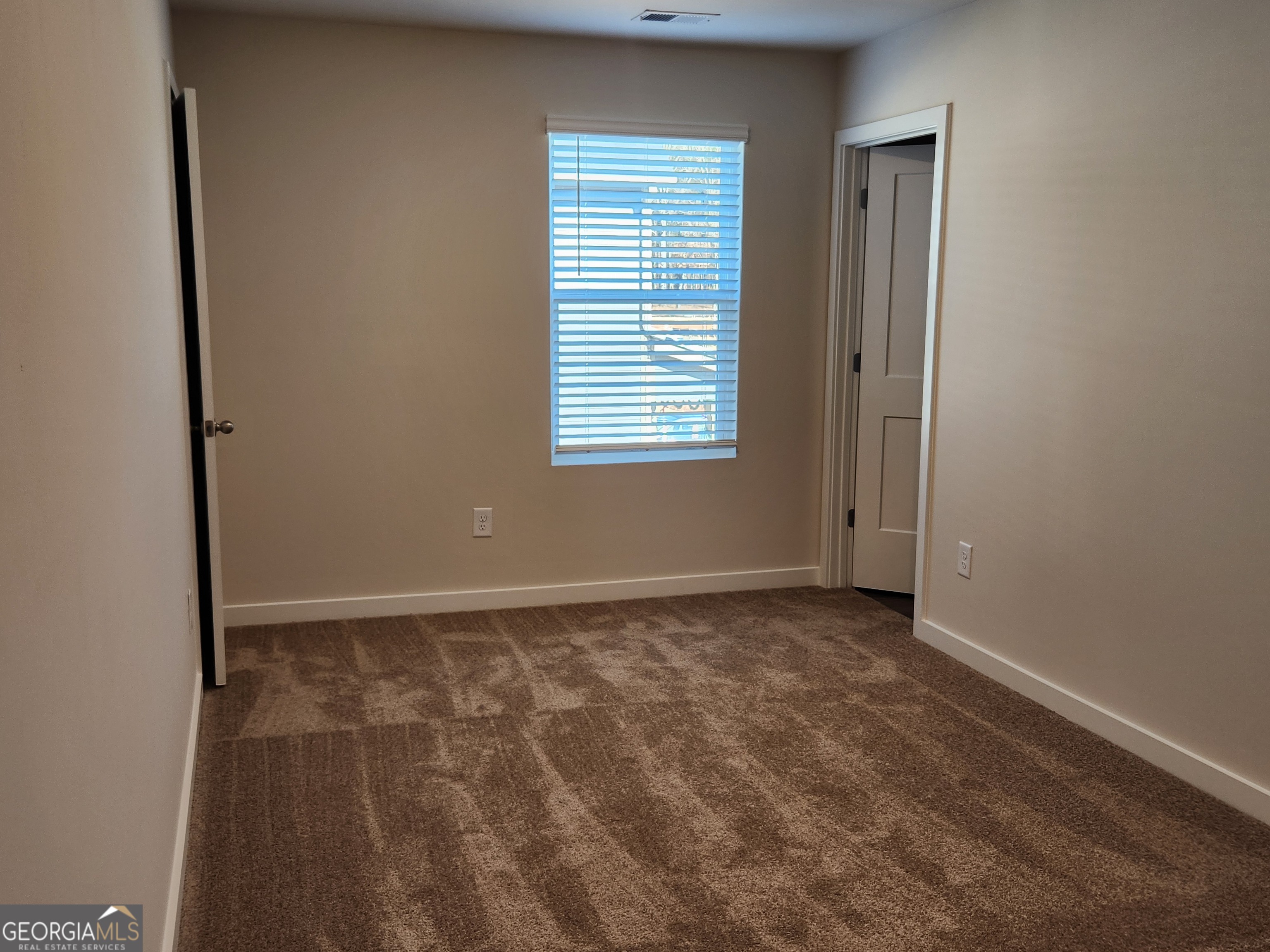 203 Crabapple Road, Unit 265 McDonough, GA 30253 - Photo 37 of 54 a view of an empty room with a window