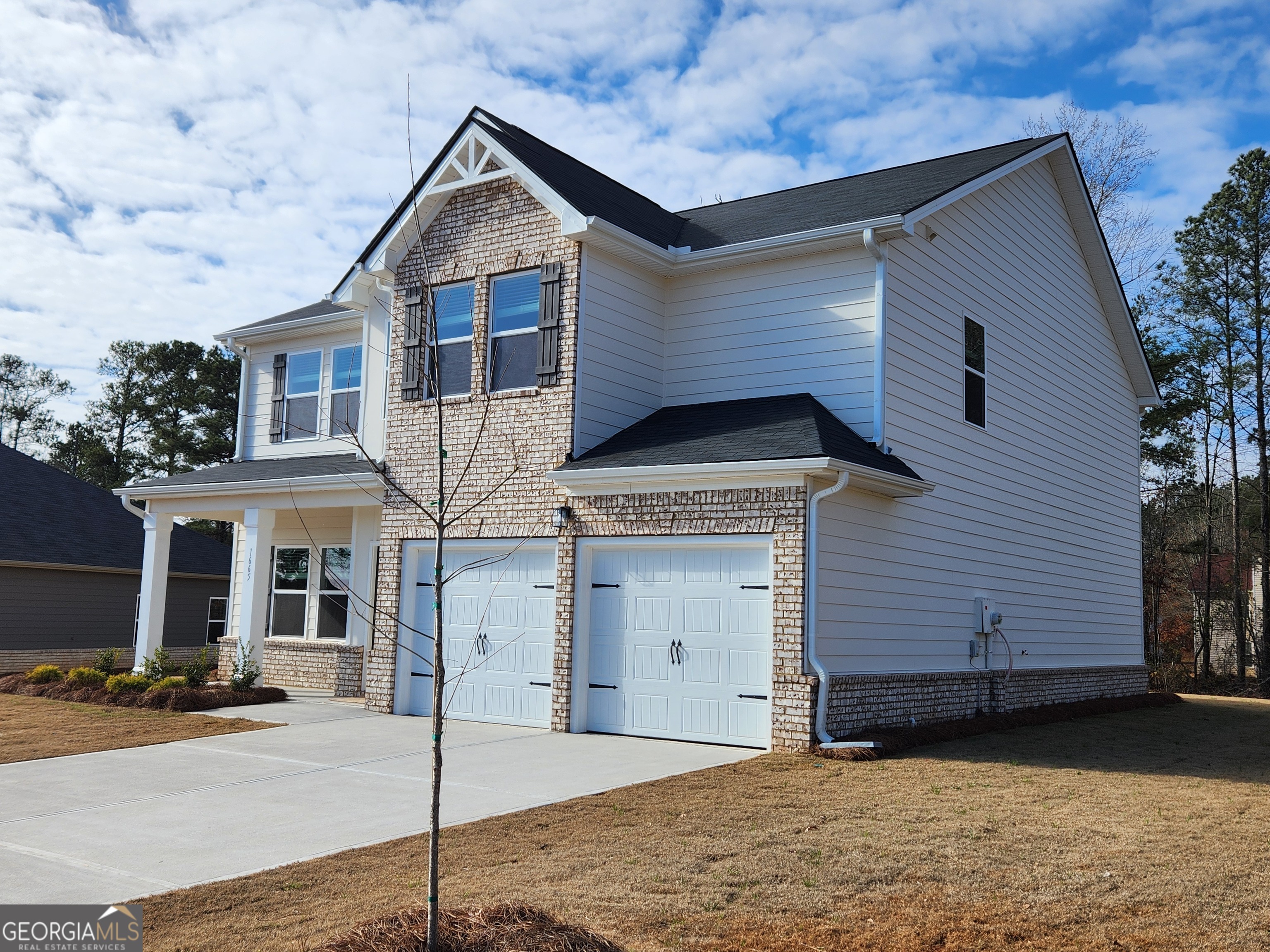203 Crabapple Road, Unit 265 McDonough, GA 30253 - Photo 4 of 54 a front view of a house with a yard and garage
