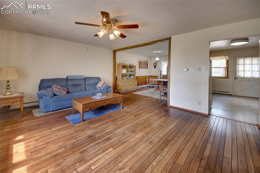 14535 Roller Coaster Road Colorado Springs, CO 80921 - Photo 9 of 43 a living room with furniture and a wooden floor