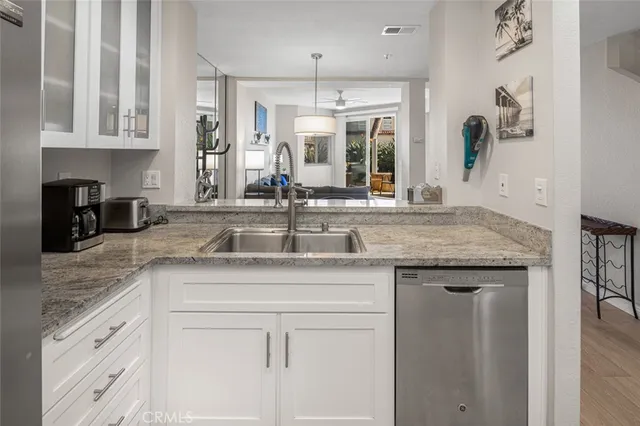 a kitchen with granite countertop a sink and cabinets