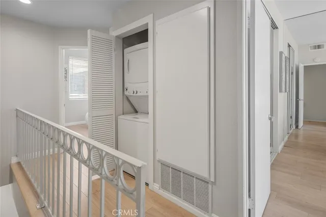 a view of a hallway with wooden floor and entryway
